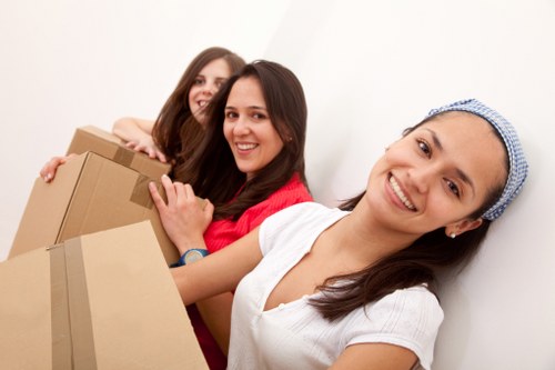 Careful loading of household items into a moving van in London