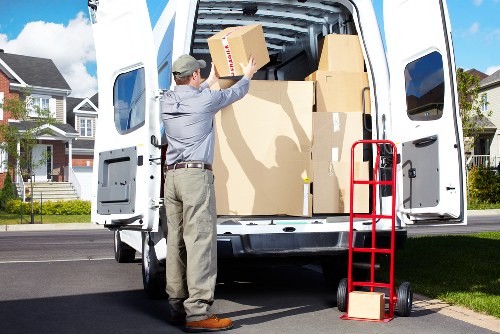 Staff coordinating a careful lift during a removal operation