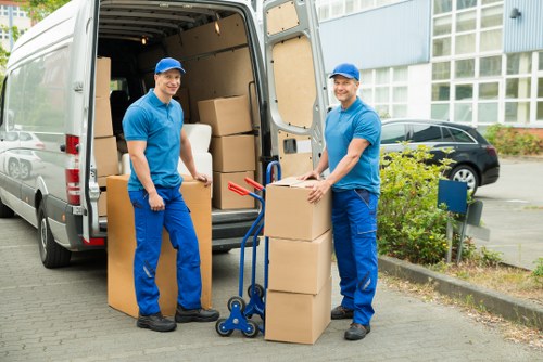 Packed boxes and furniture prepared for transport by a man and van service